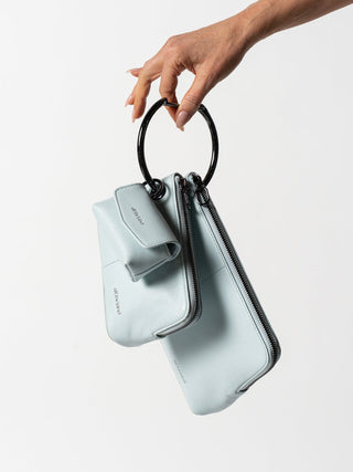 #colour_sky-gunmetal,Mini Utility Case shown with Petite Pouch and Medium Pouch (Nappa Leather) in Sky/Gunmetal, Mini Connector Clip and Grande Carabiner in Gunmetal