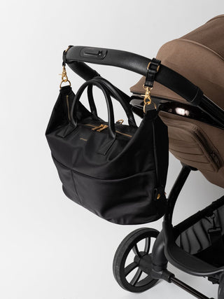 #colour_black-gold,Pictured: Ali Carryall (Nylon) and Pram Straps (Smooth Vegan), both in Black/Gold